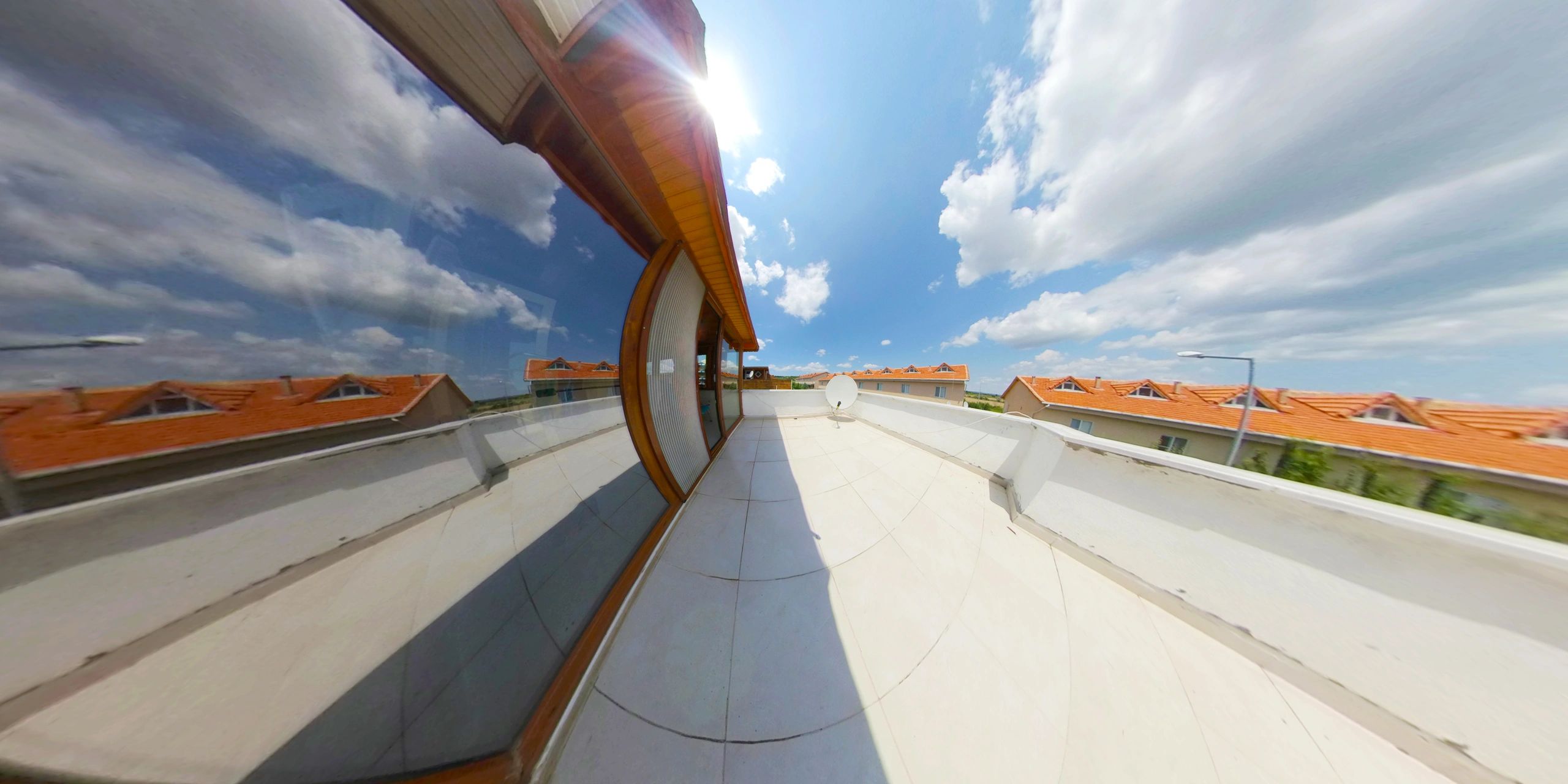 Modern home exterior roofline under blue sky