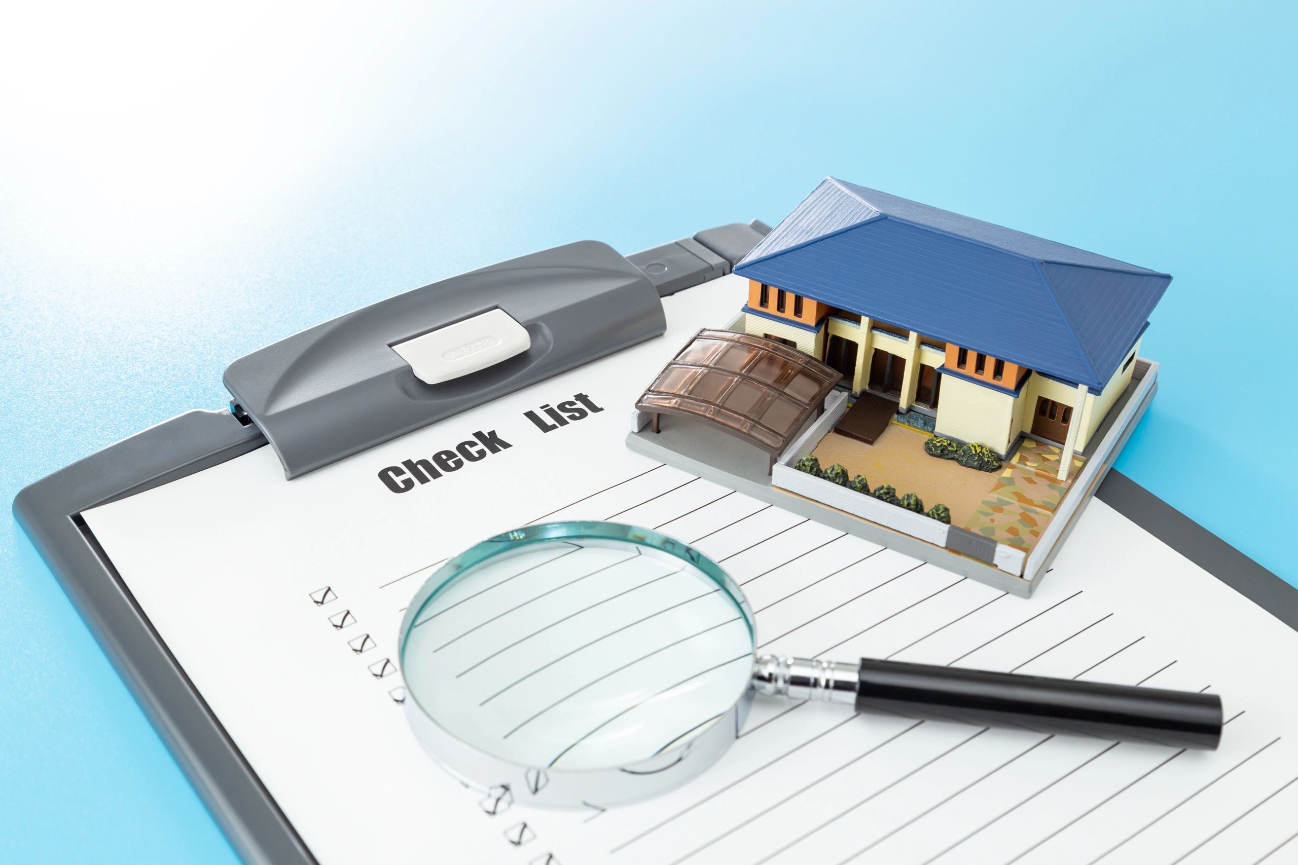 Home buying checklist beside a house model