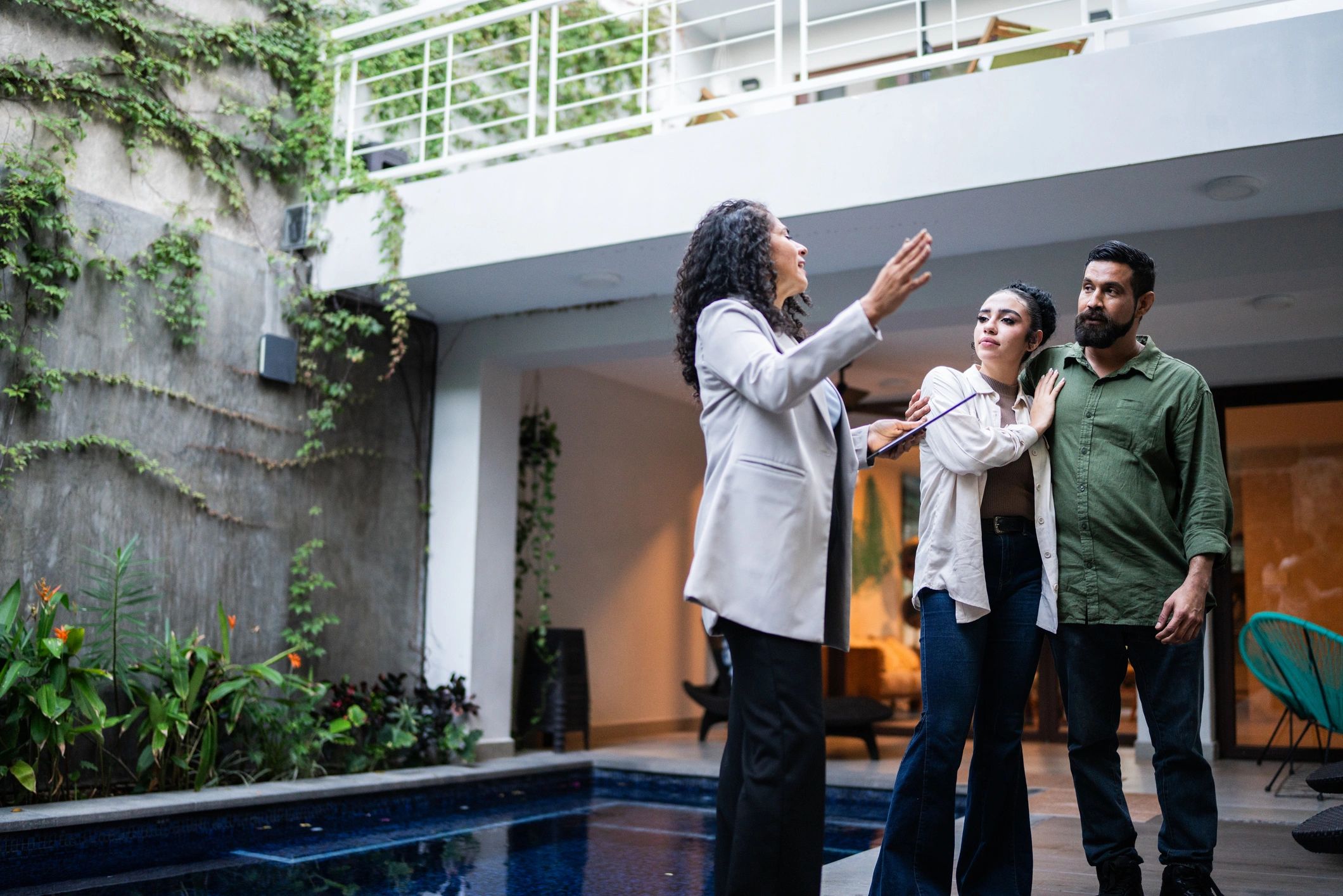 Real estate agent showing a home to a buyer couple
